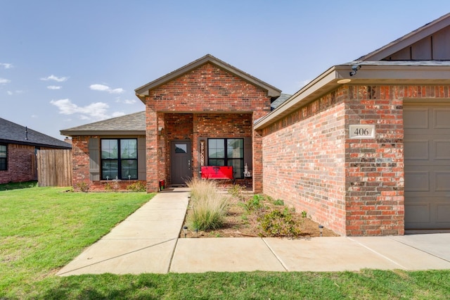 property entrance featuring a garage and a lawn