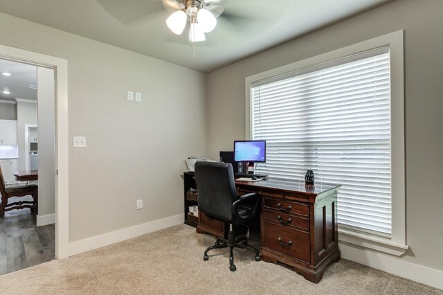 office space with light carpet and ceiling fan