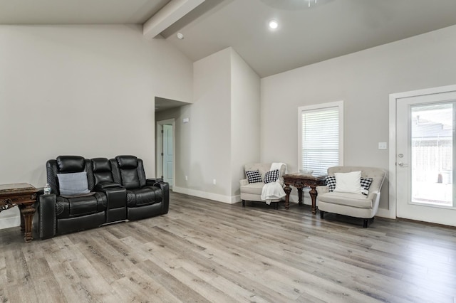 living room with high vaulted ceiling, beamed ceiling, and light wood-type flooring