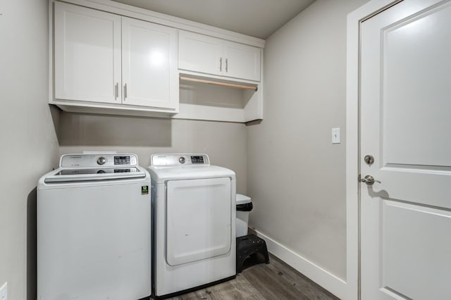 laundry room with cabinets, dark hardwood / wood-style flooring, and separate washer and dryer