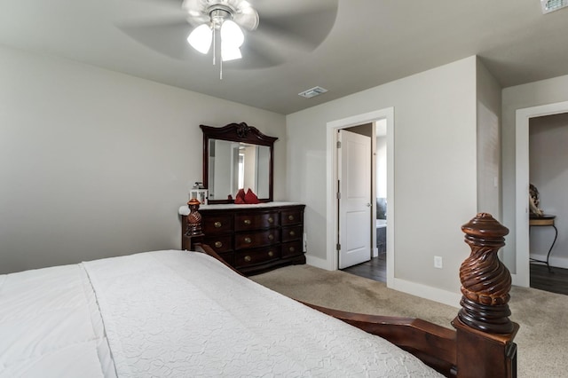 carpeted bedroom with ceiling fan and ensuite bathroom