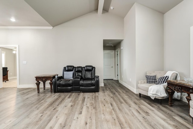 living area with beam ceiling, high vaulted ceiling, and light wood-type flooring