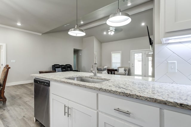 kitchen featuring sink, dishwasher, white cabinetry, light stone countertops, and decorative light fixtures