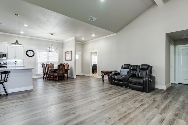 living room with ornamental molding and light wood-type flooring