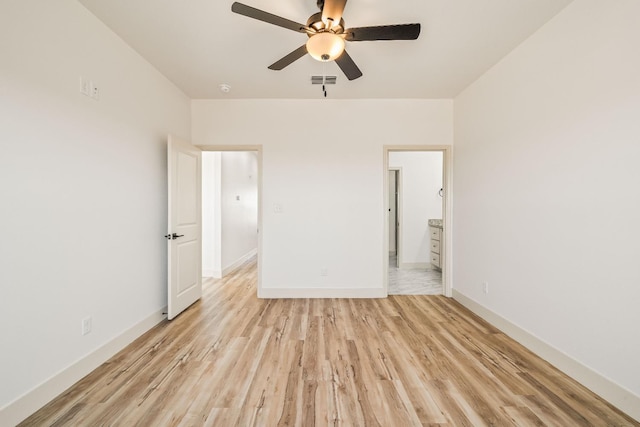 unfurnished bedroom featuring ceiling fan, connected bathroom, and light wood-type flooring