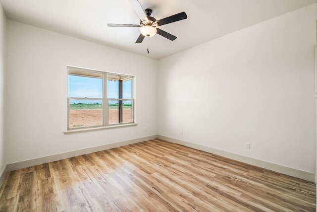 spare room featuring light hardwood / wood-style flooring and ceiling fan