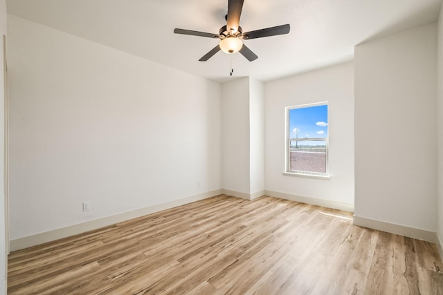 spare room featuring ceiling fan and light wood-type flooring