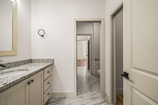 bathroom featuring vanity and toilet