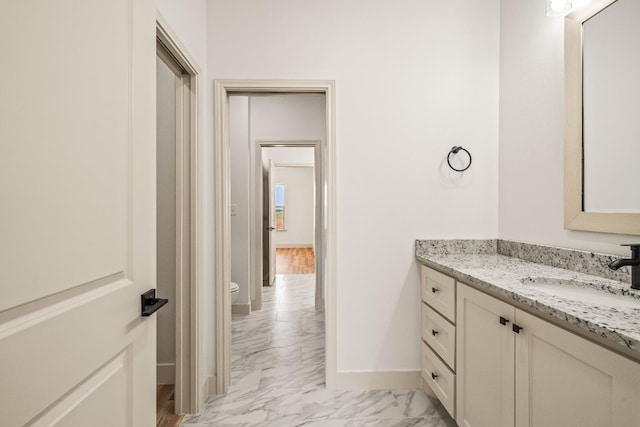 bathroom featuring vanity and toilet