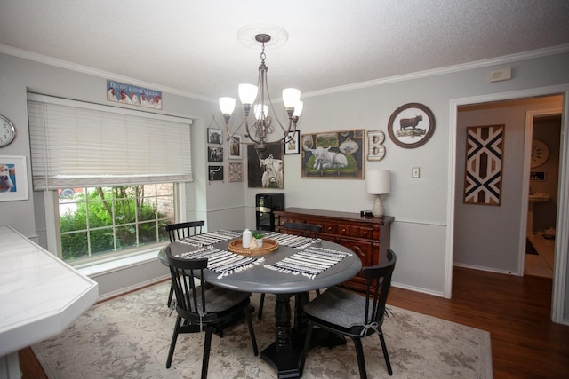 dining room featuring an inviting chandelier, ornamental molding, and wood-type flooring