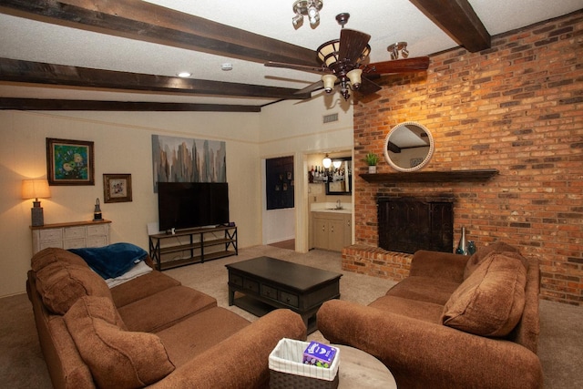 living room with ceiling fan, a fireplace, beam ceiling, and carpet