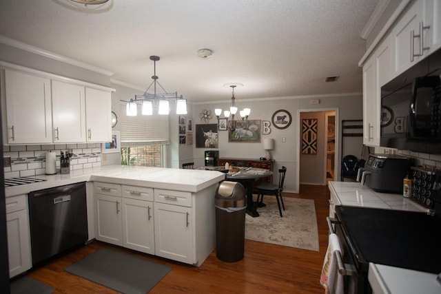 kitchen with kitchen peninsula, white cabinetry, hanging light fixtures, black appliances, and dark wood-type flooring