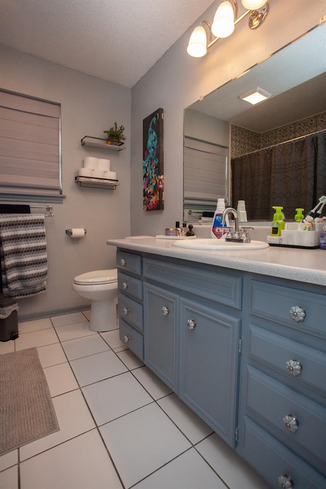 bathroom with tile patterned flooring, vanity, toilet, a textured ceiling, and a shower with curtain