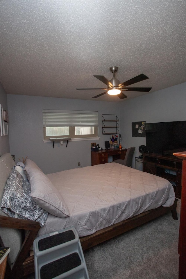 carpeted bedroom with a textured ceiling and ceiling fan