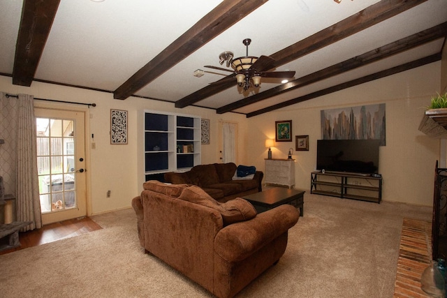 living room with lofted ceiling with beams, a brick fireplace, light colored carpet, and ceiling fan