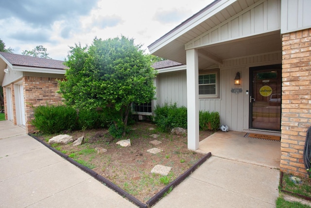 view of exterior entry with a garage