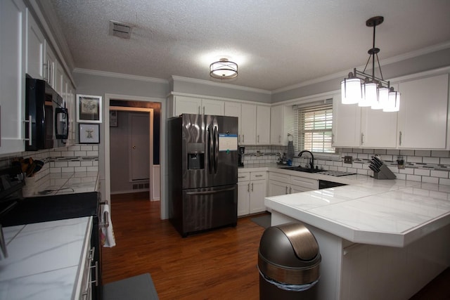 kitchen featuring white cabinetry, stainless steel fridge, hanging light fixtures, kitchen peninsula, and electric stove