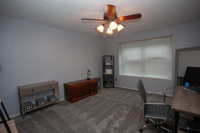 office area with ceiling fan, dark carpet, and a textured ceiling