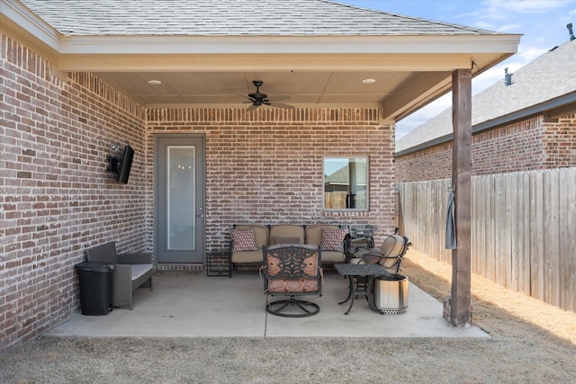 view of patio / terrace featuring an outdoor living space, a ceiling fan, and fence