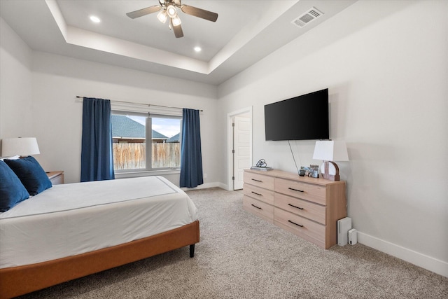 bedroom featuring a ceiling fan, visible vents, light carpet, and baseboards
