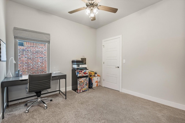carpeted home office featuring baseboards and ceiling fan