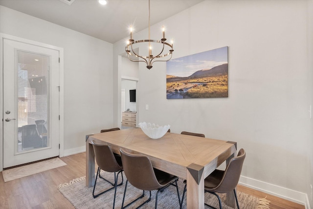 dining room featuring a chandelier, baseboards, light wood-style flooring, and recessed lighting