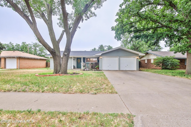 4815 15th St, Lubbock, TX 79416 - ranch-style house with an attached garage, concrete driveway, and a front yard