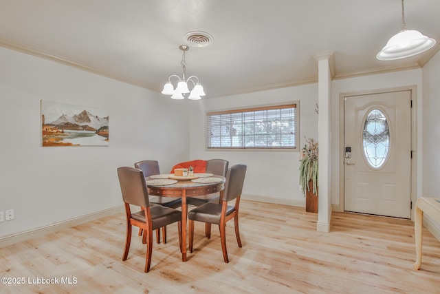 4815 15th St, Lubbock, TX 79416 - dining space featuring crown molding, wood finished floors, and a chandelier