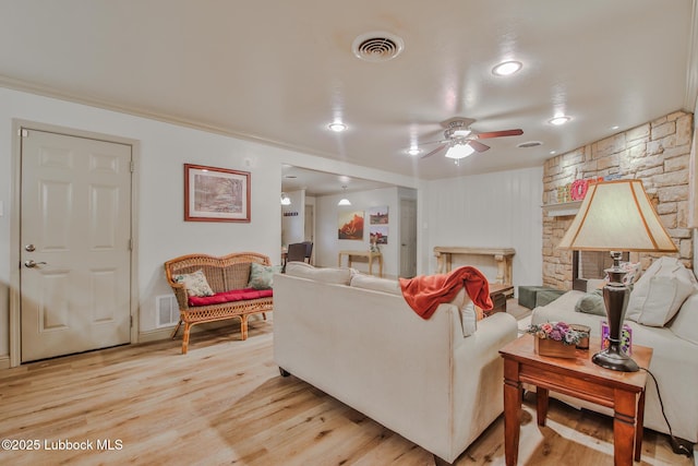 4815 15th St, Lubbock, TX 79416 - living area with a ceiling fan, light wood-style flooring, crown molding, recessed lighting, and a fireplace