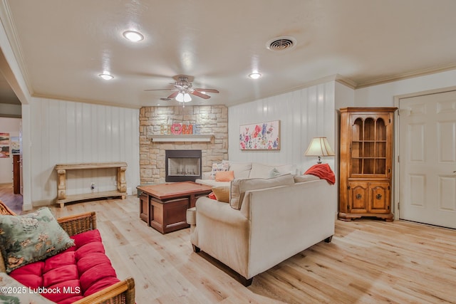 4815 15th St, Lubbock, TX 79416 - living area featuring ceiling fan, crown molding, light wood-style flooring, and a stone fireplace