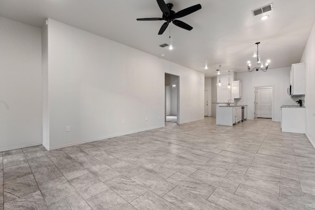 unfurnished living room with sink and ceiling fan with notable chandelier