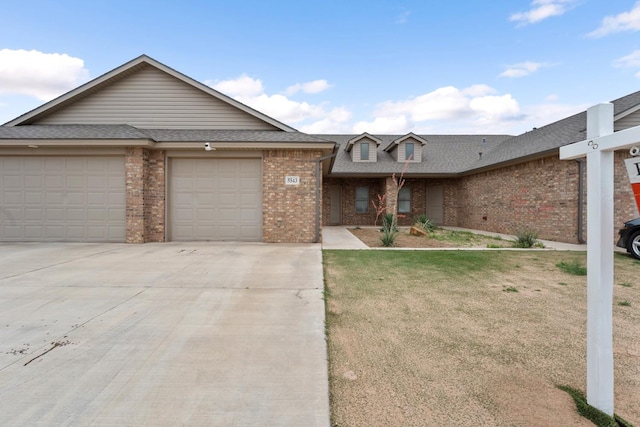 view of front of property featuring a garage and a front lawn