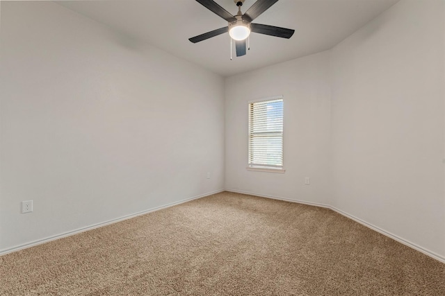 spare room with ceiling fan and carpet