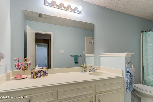 8609 Kenosha Dr, Lubbock, TX 79423 - bathroom with toilet, vanity, a textured ceiling, and curtained shower