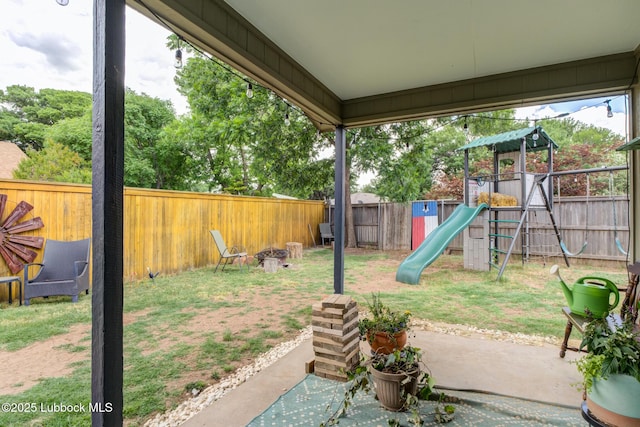 8609 Kenosha Dr, Lubbock, TX 79423 - fenced backyard featuring a playground, a patio, and a fire pit