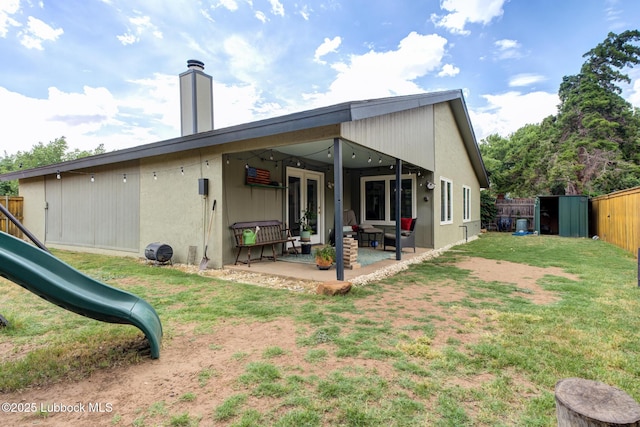 8609 Kenosha Dr, Lubbock, TX 79423 - rear view of house with a playground and a patio