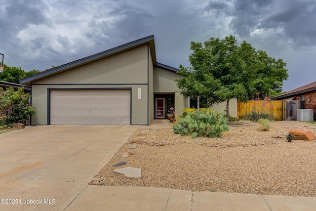 8609 Kenosha Dr, Lubbock, TX 79423 - view of front of property featuring an attached garage, concrete driveway, and central air condition unit