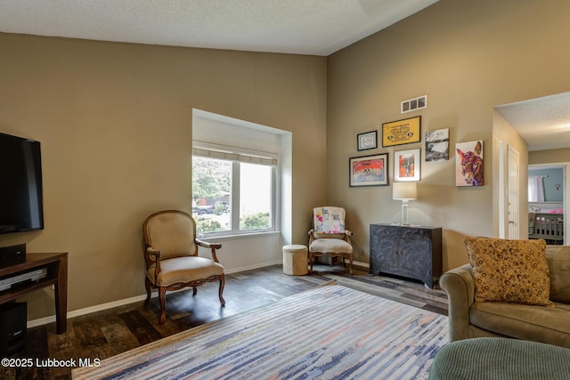 8609 Kenosha Dr, Lubbock, TX 79423 - living area featuring baseboards, wood finished floors, and high vaulted ceiling