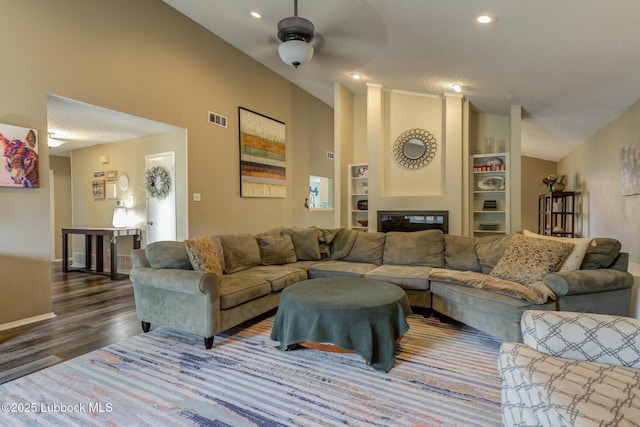 8609 Kenosha Dr, Lubbock, TX 79423 - living room featuring wood finished floors, ceiling fan, built in features, baseboards, and recessed lighting
