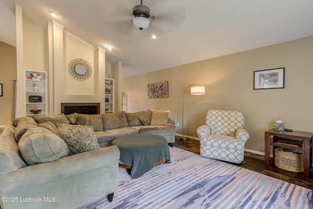 8609 Kenosha Dr, Lubbock, TX 79423 - living room with baseboards, vaulted ceiling, ceiling fan, wood finished floors, and a fireplace