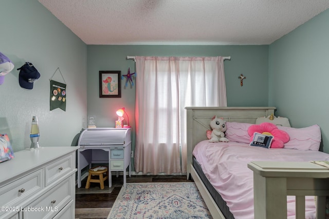 8609 Kenosha Dr, Lubbock, TX 79423 - bedroom with a textured ceiling and dark wood-type flooring