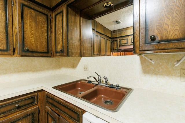 kitchen featuring sink and a textured ceiling