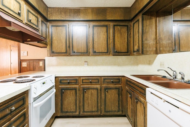 kitchen with white appliances, sink, and a textured ceiling