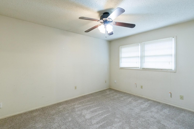 carpeted spare room featuring a textured ceiling and ceiling fan