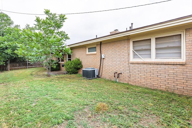 exterior space featuring a yard and central AC unit