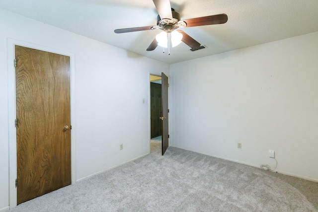 unfurnished room featuring light carpet and ceiling fan