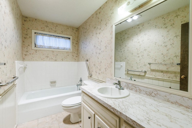 bathroom featuring vanity, toilet, tile patterned floors, and a tub to relax in