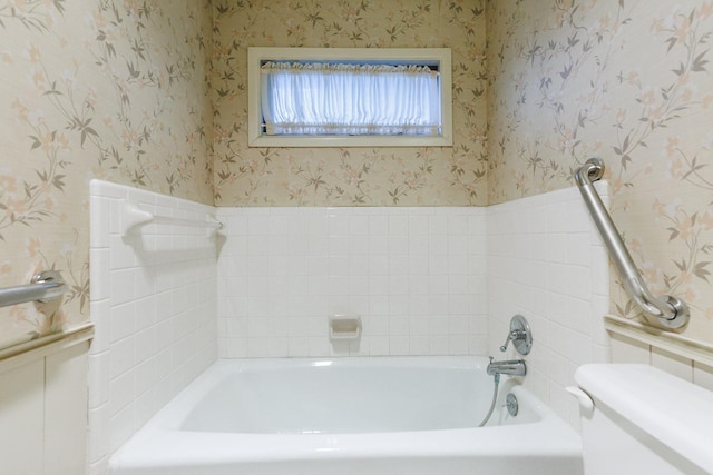 bathroom with a tub and toilet