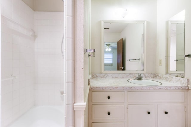 bathroom featuring vanity and tiled shower / bath combo