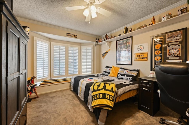 carpeted bedroom featuring ceiling fan, ornamental molding, and a textured ceiling